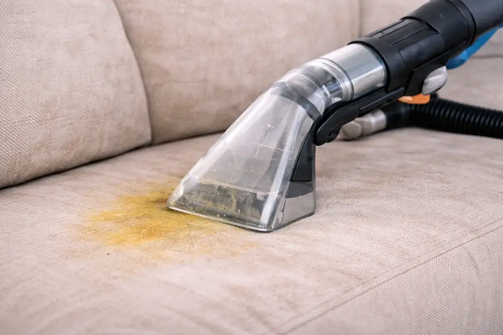 Cleaning upholstery with a vacuum tool